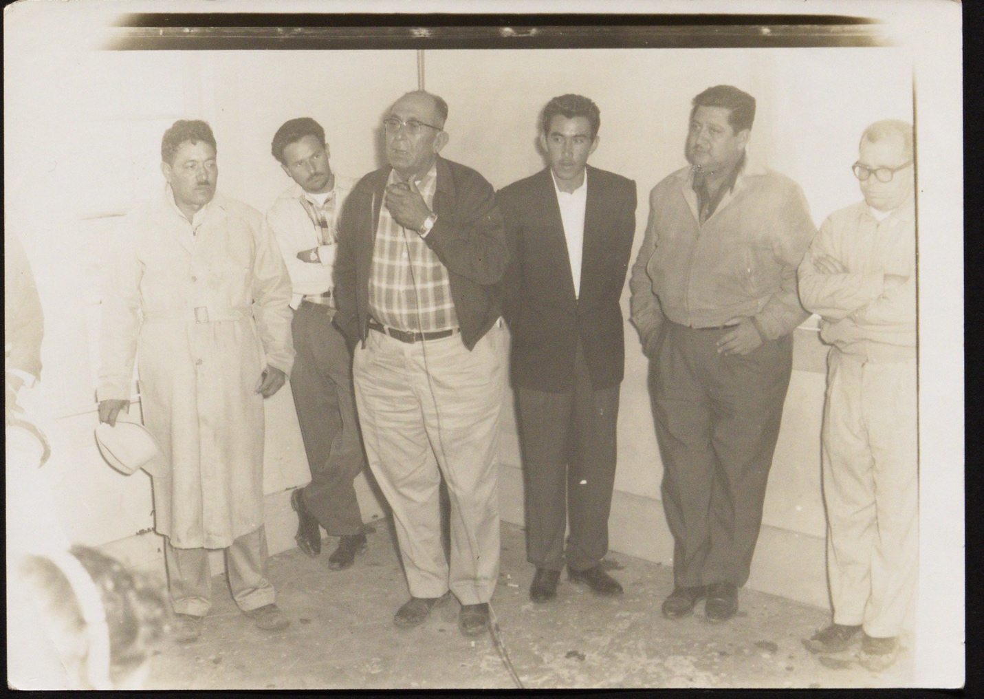 A group of men standing together

Description automatically generated